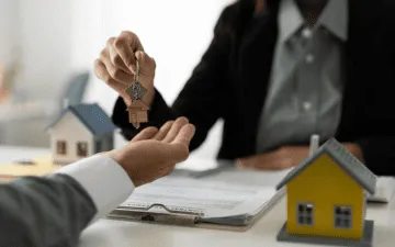 Proprietário entregando as chaves de imóvel após empresa contratar seguro fiança locatícia