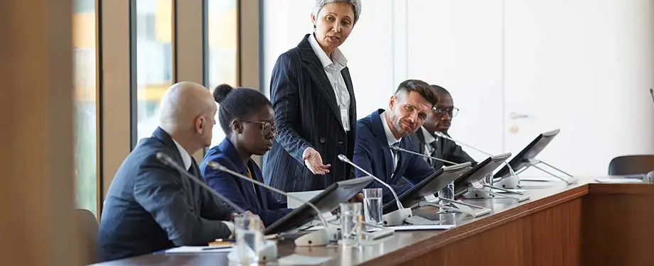 Qual a função do CARF? Na imagem, profissionais dialogam, representando as decisões oriundas da nova lei, relacionadas a questões como voto de qualidade e garantia em processos judiciais
