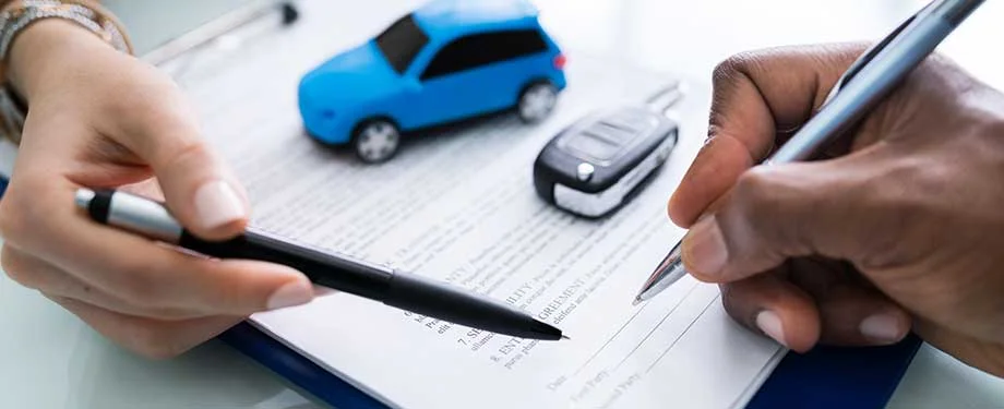 Quanto custa um seguro de carro alugado? Na imagem, contrato e carros em miniatura representam a import&acirc;ncia do seguro para prote&ccedil;&atilde;o contra riscos na loca&ccedil;&atilde;o de ve&iacute;culos 