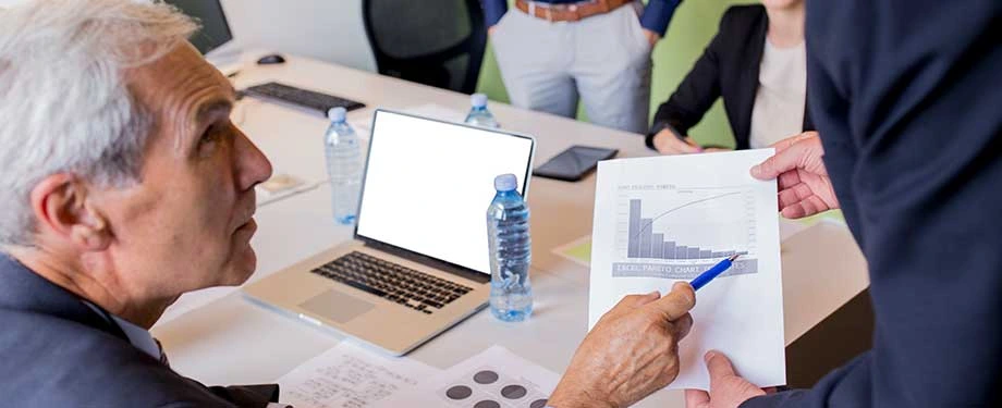 Qual é o valor do seguro multirrisco empresarial? Na imagem, empreendedor analisa dados sobre seu negócio, evidenciando a importância de gerir riscos com o seguro